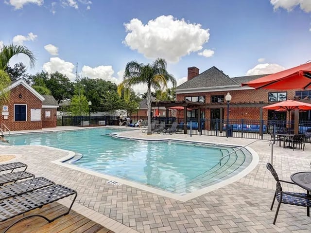 Pool with lounge chairs and umbrellas exterior at The Province in Louisville Student Accommodation