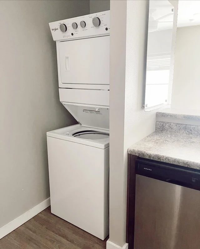 Stacked washer dryer and dishwasher kitchen area at Fireside District Apartments in Stephenville Student Accommodation