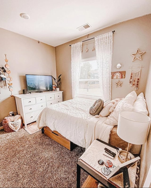 Bed dresser TV window wall decor bedroom at Fireside District Apartments in Stephenville Student Accommodation