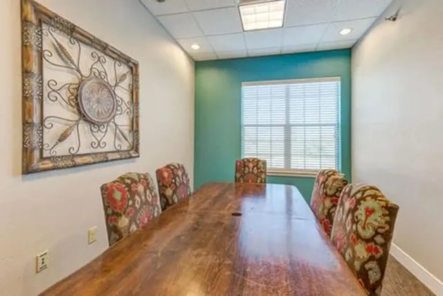 Large wooden table chairs artwork and window meeting room at Campus Village Apartments in College Station Student Accommodation