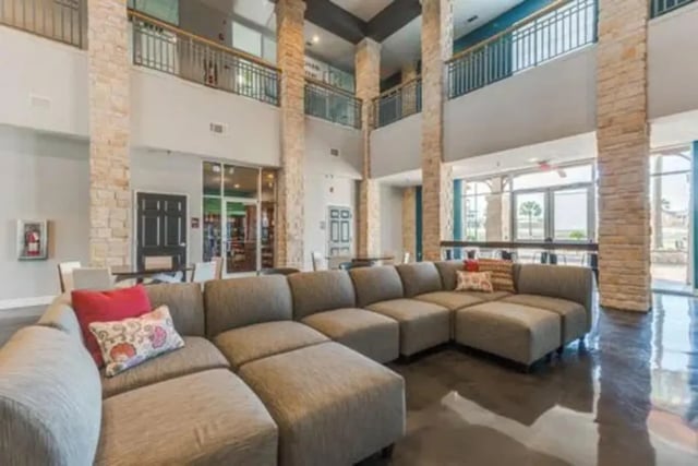 Large sectional sofa with pillows common area living room at Campus Village Apartments in College Station Student Accommodation