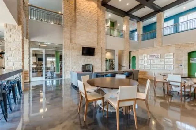Chairs around tables in communal living room at Campus Village Apartments in College Station Student Accommodation