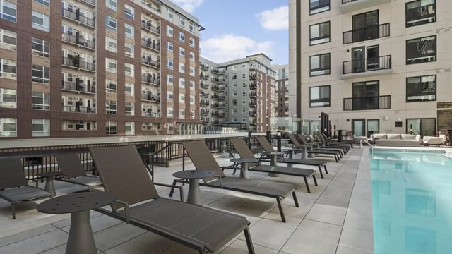 Lounge chairs pool and buildings outdoor area at The Dorsey in Denver Student Accommodation