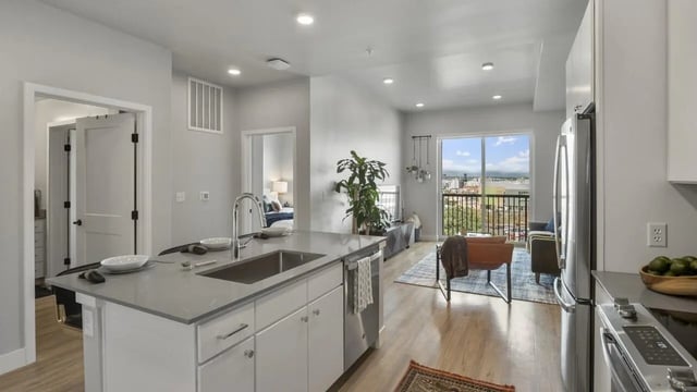 Kitchen island with sink living room and balcony living room at The Dorsey in Denver Student Accommodation