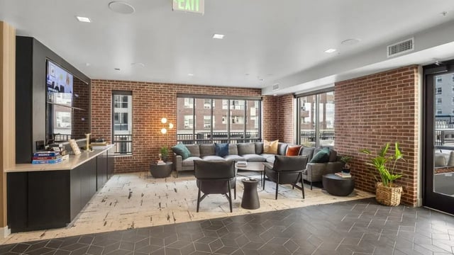 Sofa chairs coffee table television lounge living room at The Dorsey in Denver Student Accommodation