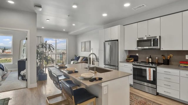 Modern kitchen with island and living area kitchen at The Dorsey in Denver Student Accommodation