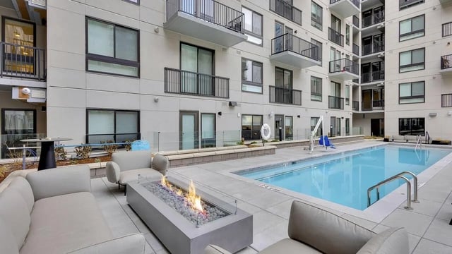 Apartment building with pool and seating area exterior at The Dorsey in Denver Student Accommodation