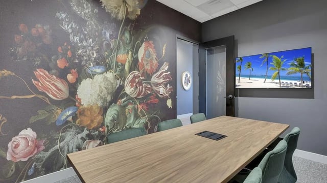 Floral wallpaper wooden table and beach TV meeting room at The Dorsey in Denver Student Accommodation