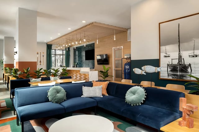 Blue sectional sofa with pillows lounge living area at Dockside Clemson in Clemson Student Accommodation