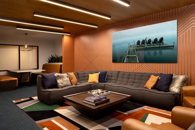 Grey sectional sofa with pillows on geometric rug living room at Dockside Clemson in Clemson Student Accommodation
