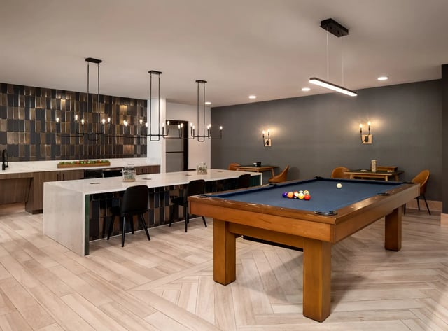Pool table kitchen island modern chandelier recreation area at Dockside Clemson in Clemson Student Accommodation