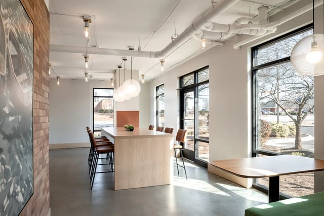 Large wooden table with chairs and artwork communal area at Dockside Clemson in Clemson Student Accommodation