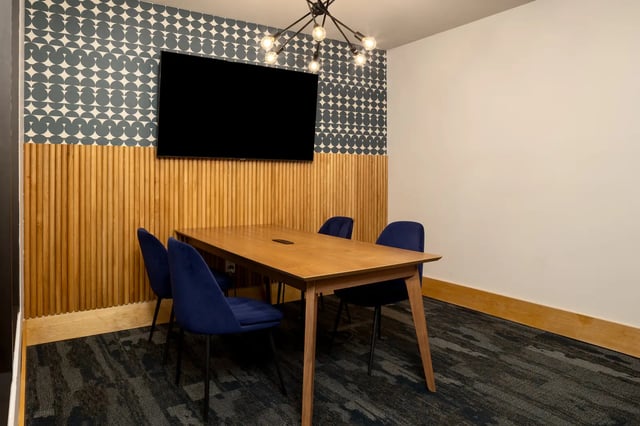 Wooden table blue chairs television study area at Dockside Clemson in Clemson Student Accommodation