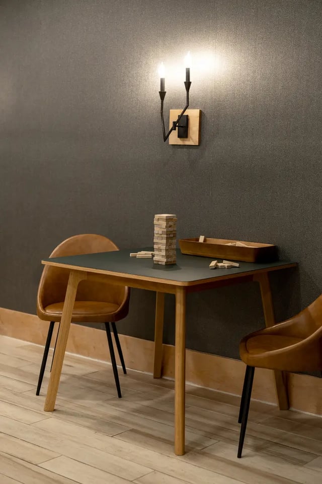 Table chairs Jenga game wall sconce playing area at Dockside Clemson in Clemson Student Accommodation
