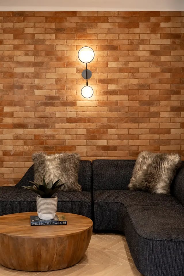Modern wall light sofa table and plant living room at Dockside Clemson in Clemson Student Accommodation