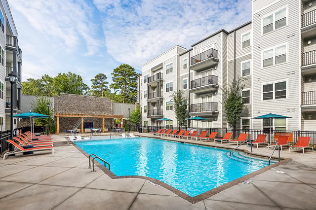 Pool lounge chairs and umbrellas outdoor living area exterior at Dockside Clemson in Clemson Student Accommodation