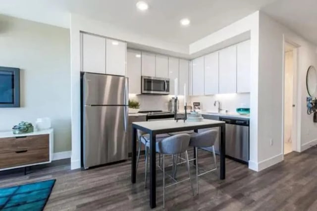 Stainless steel refrigerator kitchen island and chairs kitchen at The Dwight by Arthaus in Berkeley Student Accommodation