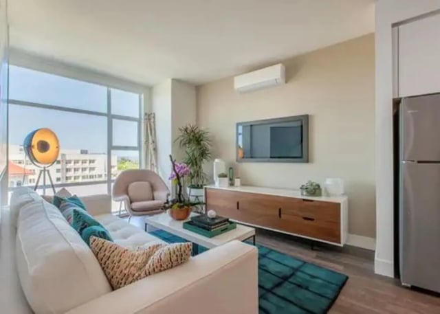 Sofa armchair TV console and floor lamp living room at The Dwight by Arthaus in Berkeley Student Accommodation