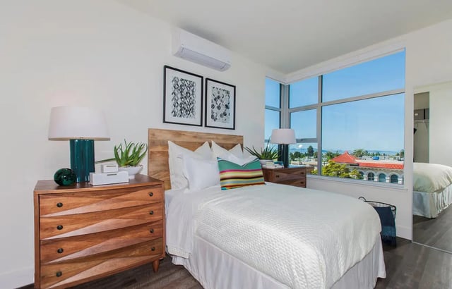 Wooden dresser bed and artwork bedroom at The Dwight by Arthaus in Berkeley Student Accommodation
