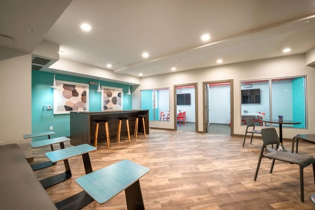 Bar with stools study rooms and seating area communal space at Campus Vue Apartments in Houston Student Accommodation