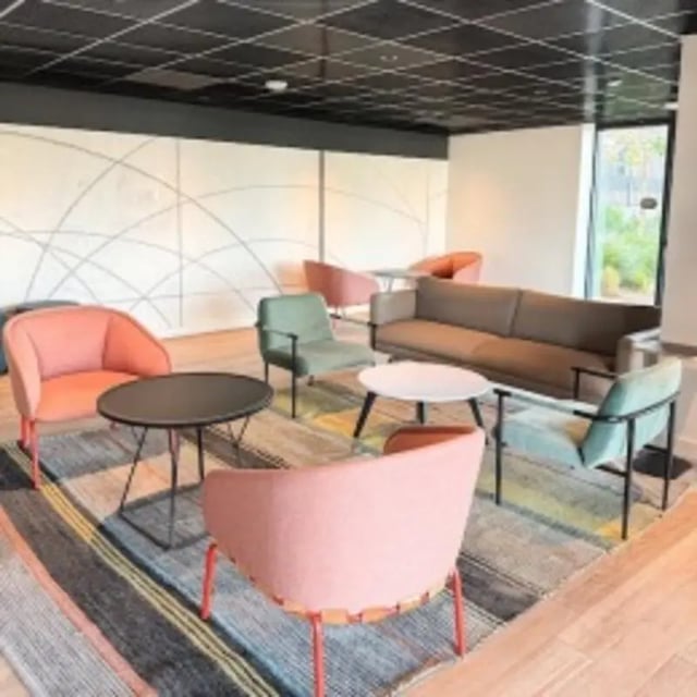 Sofa chairs tables on rug living room at Union Grantville in San Diego Student Accommodation