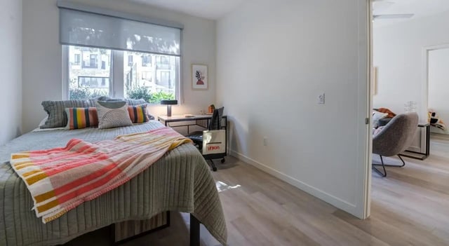 Bed desk chair and colorful blanket bedroom at Union Grantville in San Diego Student Accommodation
