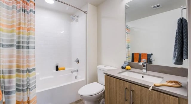 Bathtub toilet sink vanity and shower curtain bathroom at Union Grantville in San Diego Student Accommodation