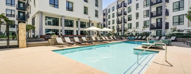 Pool with lounge chairs and umbrellas exterior at Union Grantville in San Diego Student Accommodation
