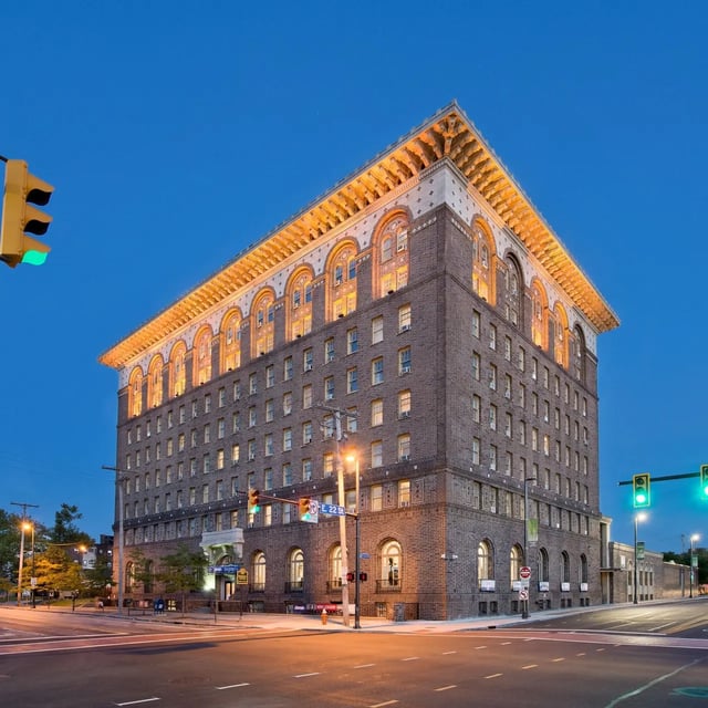 Brick building with arched windows and ornate roof exterior at Domain at Cleveland in Cleveland Student Accommodation