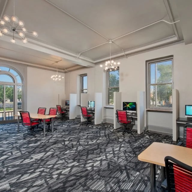 Computers desks and red chairs study area at Domain at Cleveland in Cleveland Student Accommodation