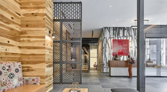 Wood paneling patterned sofa desk receptionist living area at The Hamilton in Philadelphia Student Accommodation