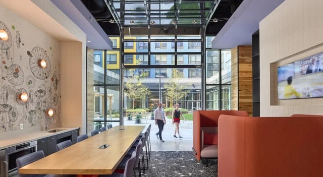 Long table wall art TV and seating area communal space at The Hamilton in Philadelphia Student Accommodation