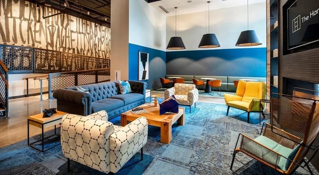 Blue couch patterned chairs wood table lounge area at The Hamilton in Philadelphia Student Accommodation