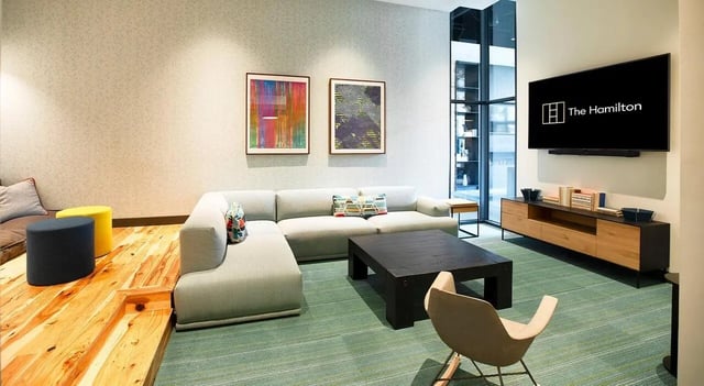 Sofa coffee table artwork television living room at The Hamilton in Philadelphia Student Accommodation