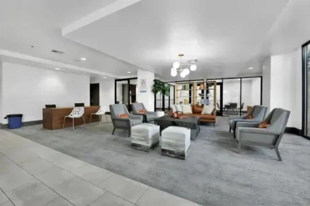 Lounge area with chairs desk and couches living room at GrandMarc Austin in Austin Student Accommodation