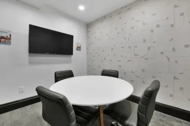 Round table four chairs mounted tv study area at GrandMarc Austin in Austin Student Accommodation