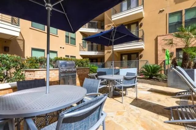 Grill umbrellas tables and chairs outdoor area at GrandMarc Austin in Austin Student Accommodation