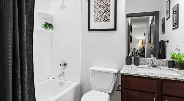 Modern bathroom with bathtub toilet sink and vanity Bathroom at The Local Downtown in San Marcos Student Accommodation