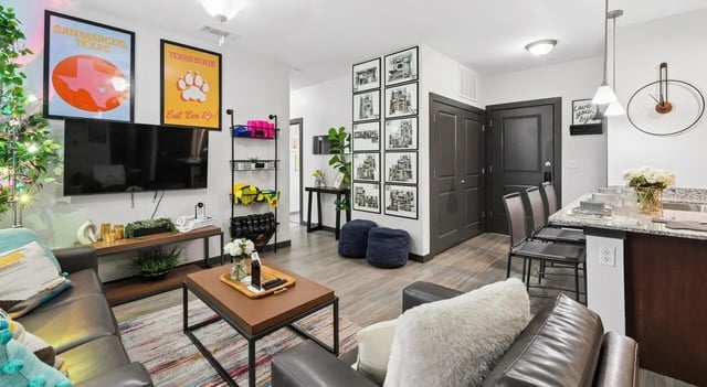 Sofa television shelf and kitchen island living room at The Local Downtown in San Marcos Student Accommodation