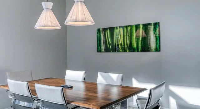 Table with chairs and modern art communal area at The Chestnut in Philadelphia Student Accommodation