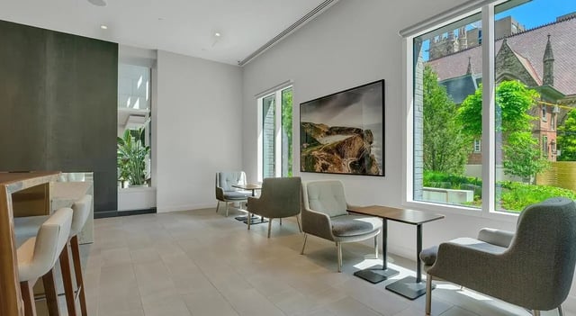 Seating area with chairs tables and artwork communal area at The Chestnut in Philadelphia Student Accommodation