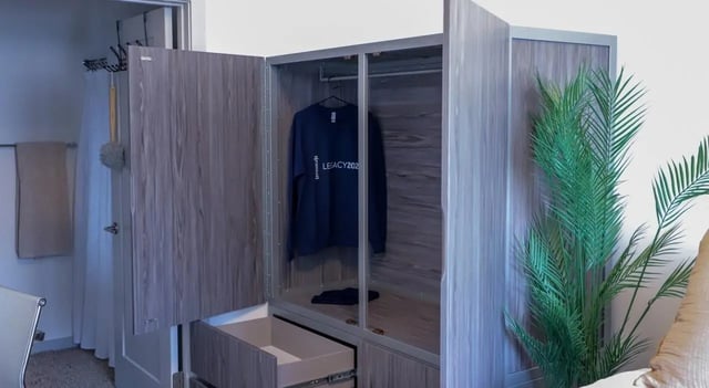 Wardrobe with clothes and plant Bedroom at Legacy202 Apartments in Champaign Student Accommodation