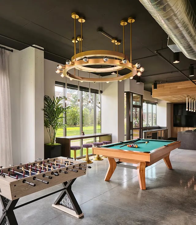 Foosball table pool table and bar stools common area at Flatiron in Baton Rouge Student Accommodation