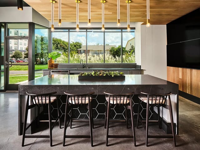 Modern kitchen island with bar stools and large windows kitchen at Flatiron in Baton Rouge Student Accommodation