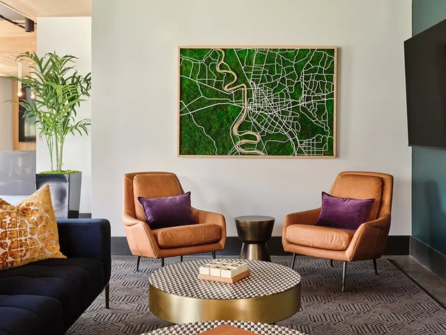 Two leather armchairs with purple pillows living room at Flatiron in Baton Rouge Student Accommodation