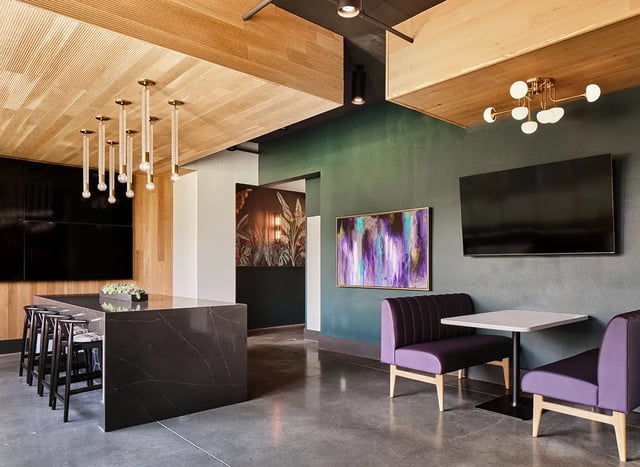 Modern lounge area with kitchen island and seating at Flatiron in Baton Rouge Student Accommodation