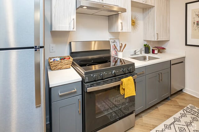Stainless steel refrigerator stove gray cabinets kitchen at Flatiron in Baton Rouge Student Accommodation