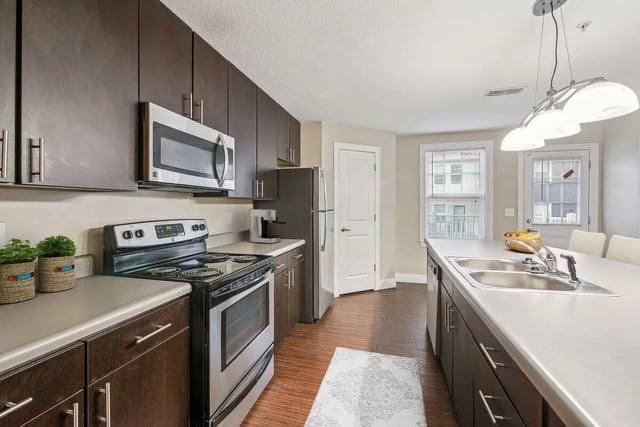 Modern kitchen with dark cabinets oven microwave kitchen at Magnolia, A Prosper Community in Tuscaloosa Student Accommodation