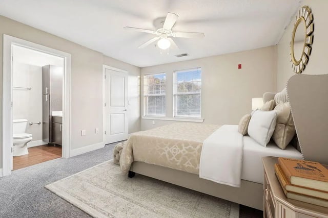 Bed with closet and toilet visible bedroom at Magnolia, A Prosper Community in Tuscaloosa Student Accommodation