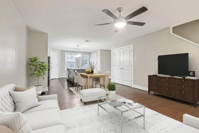 White sofa dining table kitchen and TV living room at Magnolia, A Prosper Community in Tuscaloosa Student Accommodation